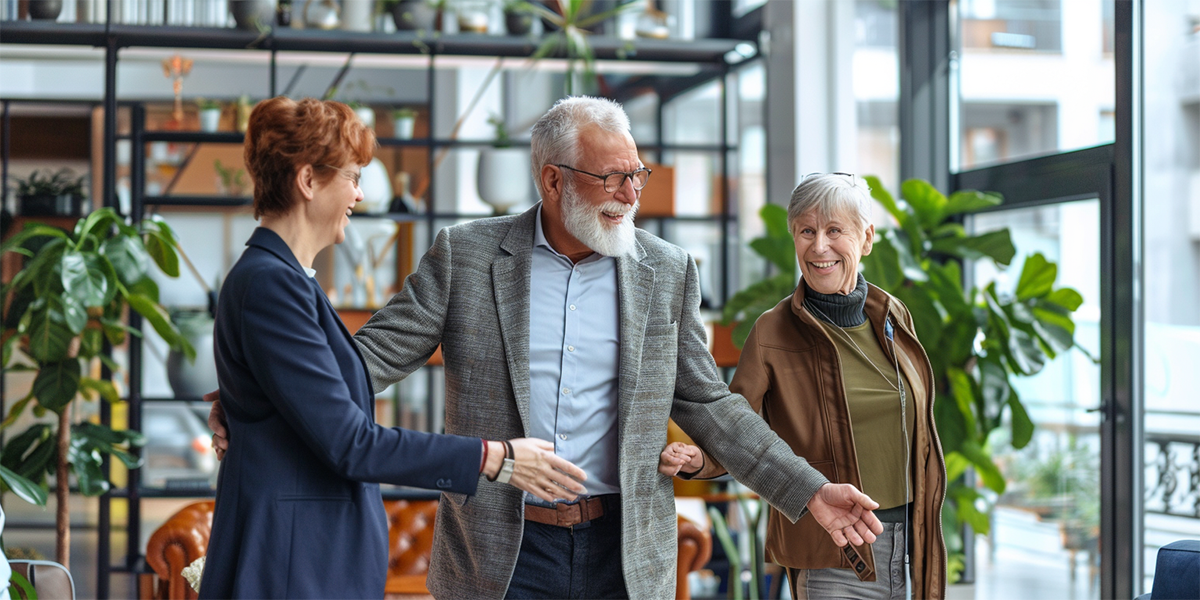 old couple talking to their real estate agent about selling their house